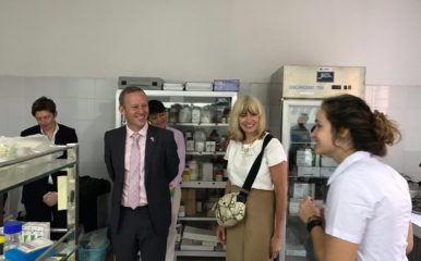 Christine Middlemiss and Gareth Ward being shown the laboratory