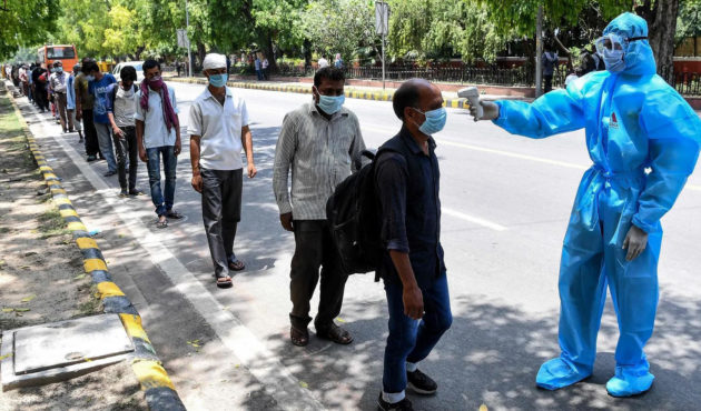 People queueing for health checks in India