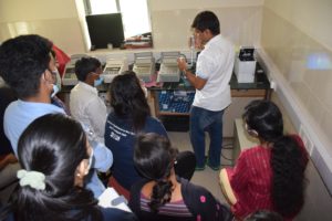 man demonstrating lab techniques to students in a training session