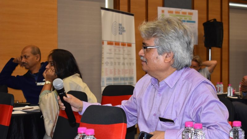 Nitish Debnath holding a mic in a conference setting