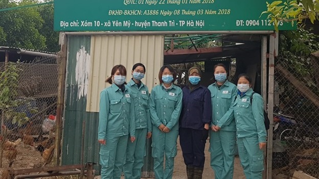 sampling team in PPI in front of a building