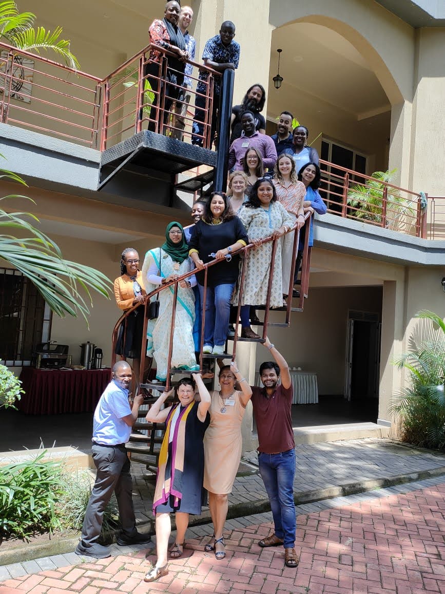 Group image of researchers up a spiral staircase