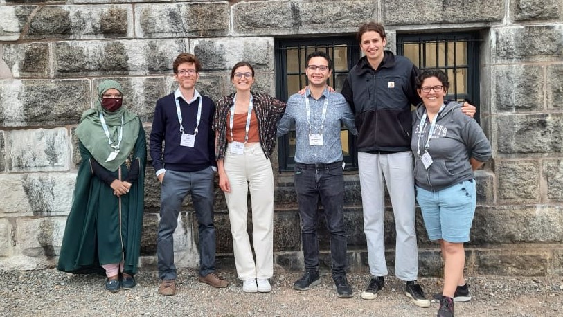 team pic of isvee presenters standing against a wall