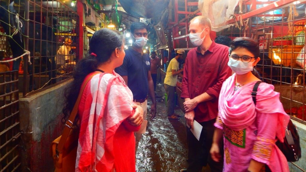 researchers in a live bird market setting