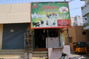 shop frontage with a sign depicting images of chickens