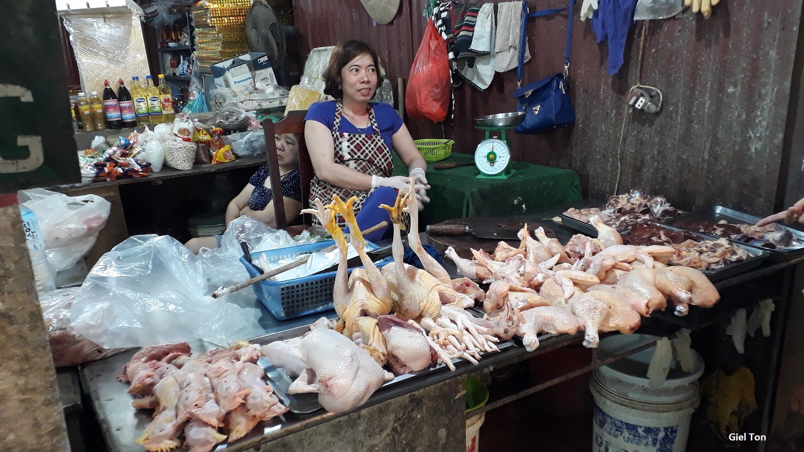 woman at market stall selling chickens in Vietnam