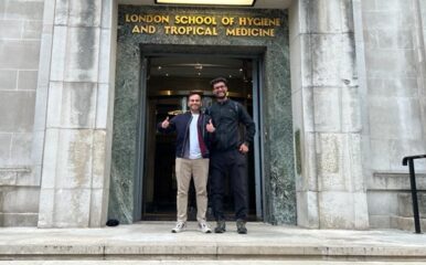 two men standing on steps of LSHTM