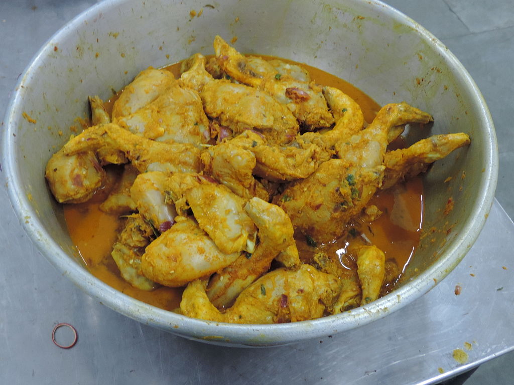 pieces of cooked chicken and sauce in a bowl