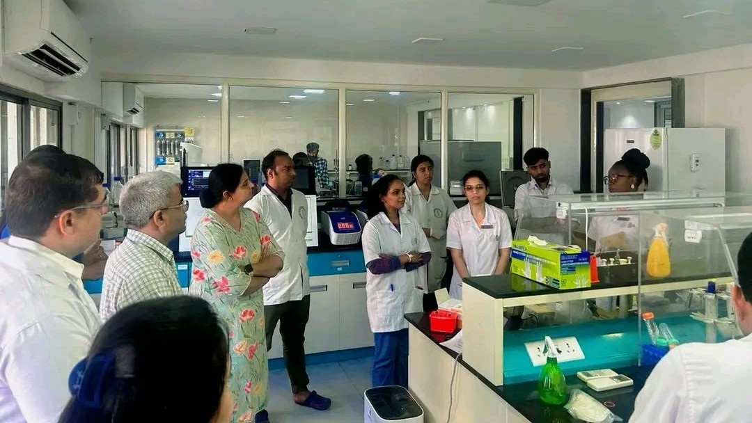 group of people in white lab coats in a laboratory ssetting